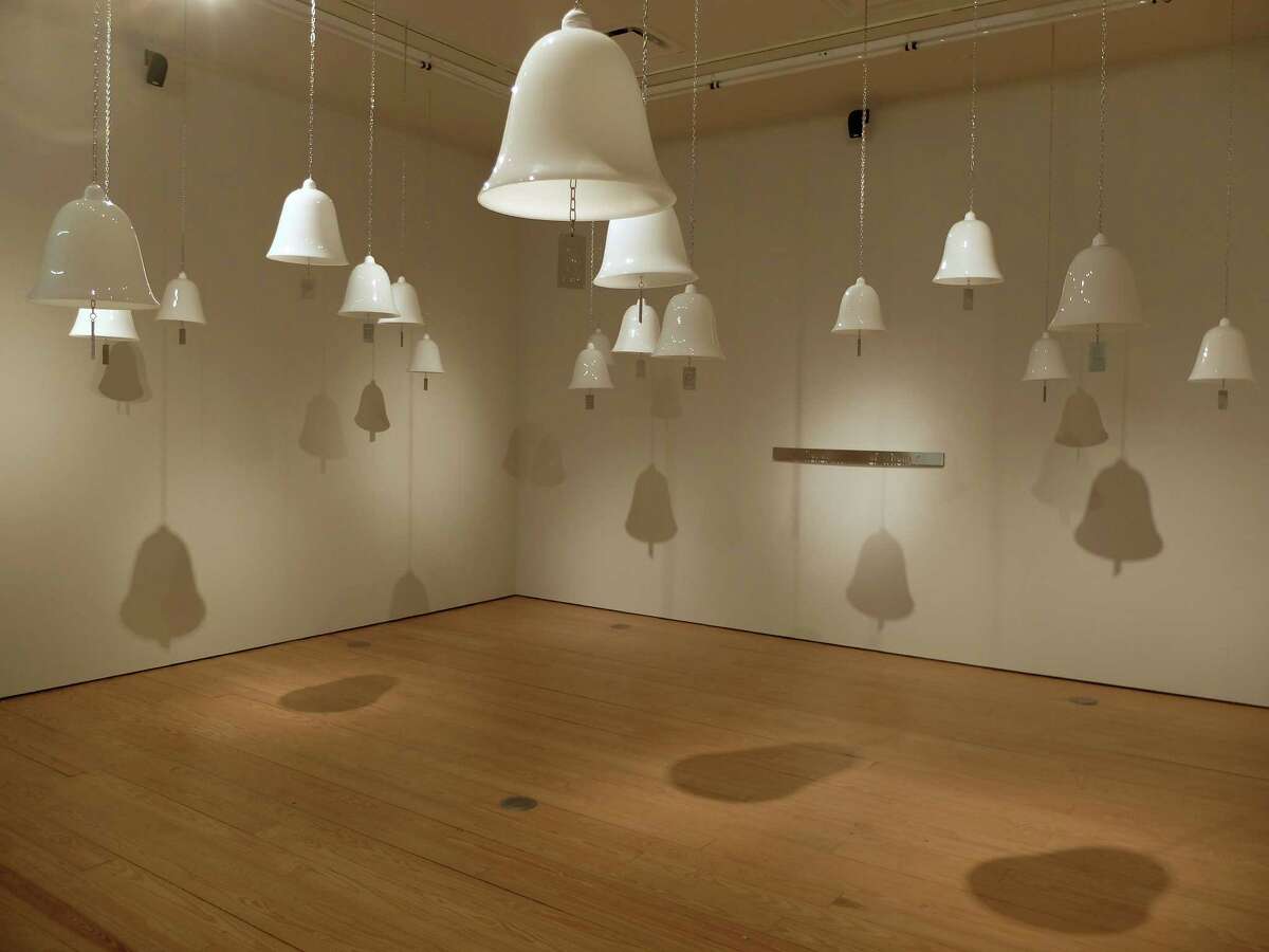 Artist Marie Orensanz's installation "...a path to share..." consists of 20 opaline cloches, each contains a stainless-steel pendant with a message. The work is on view at Sicardi Gallery through Saturday.﻿