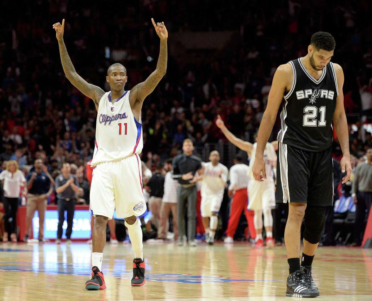 Jamal Crawford of the Clippers celebrates in front of Tim Duncan of the Spurs during a 119-115 L.A. win at Staples Center on Feb. 19, 2015, in Los Angeles.