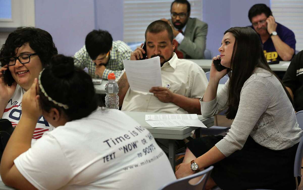 Erica Wadzinski, right, and other workers for Mi Familia Vota-San Antonio and Service Employees International Union, conduct a phone bank to urge Governor Greg Abbot and Attorney General Ken Paxton to drop legal action against the President's immigrant plan. April 17, 2015.