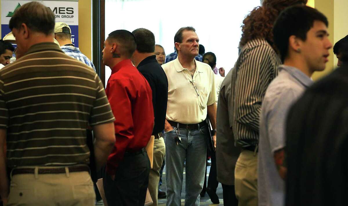 Mark Adams walks into the packed Associated General Contractors job fair at the San Antonio Airport Hilton. Wednesday, April 15, 2015.