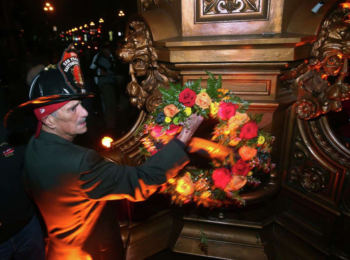 Ron Ross, president of the San Francisco History Association, adjusts a wreath placed on Lotta's Fountain to commemorate the 109th anniversary of the 1906 earthquake in San Francisco, Calif. on Saturday, April 18, 2015.