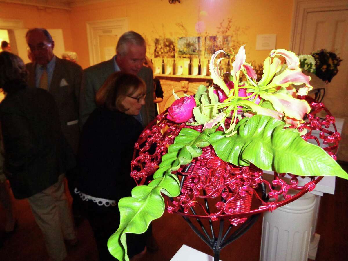 Floral designs created to resemble hats were a hit with the hundreds of patrons and flower club members who attended a preview party for the Fairfield Garden Club's Centennial Flower Show at the Burr Homestead on Friday.