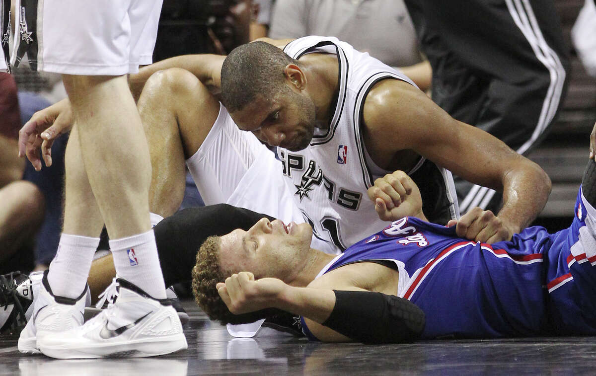 Spurs' Tim Duncan (21) checks on Los Angeles Clippers' Blake Griffin (32) after Duncan committed a hard foul while attempting a block in the second half at the AT&T Center on Friday, Mar. 29, 2013. The Spurs defeated the Clippers, 104-102.