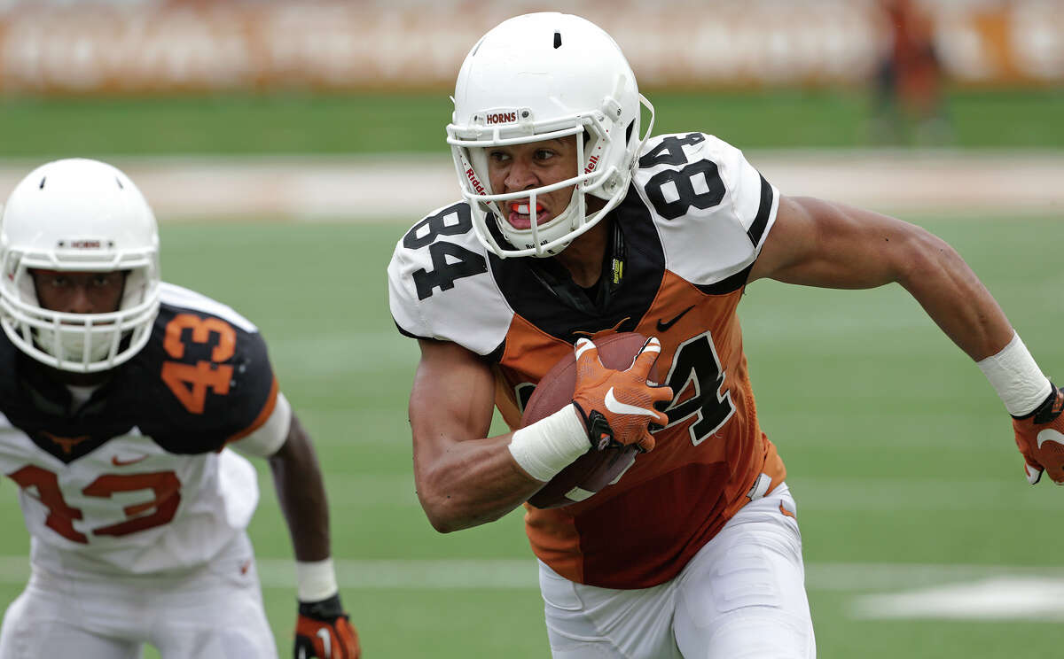 Lorenzo Joe gets away fromJordan Strickland after a catch as the Longhorns play their spring game in DKR Stadium on April 18, 2015.