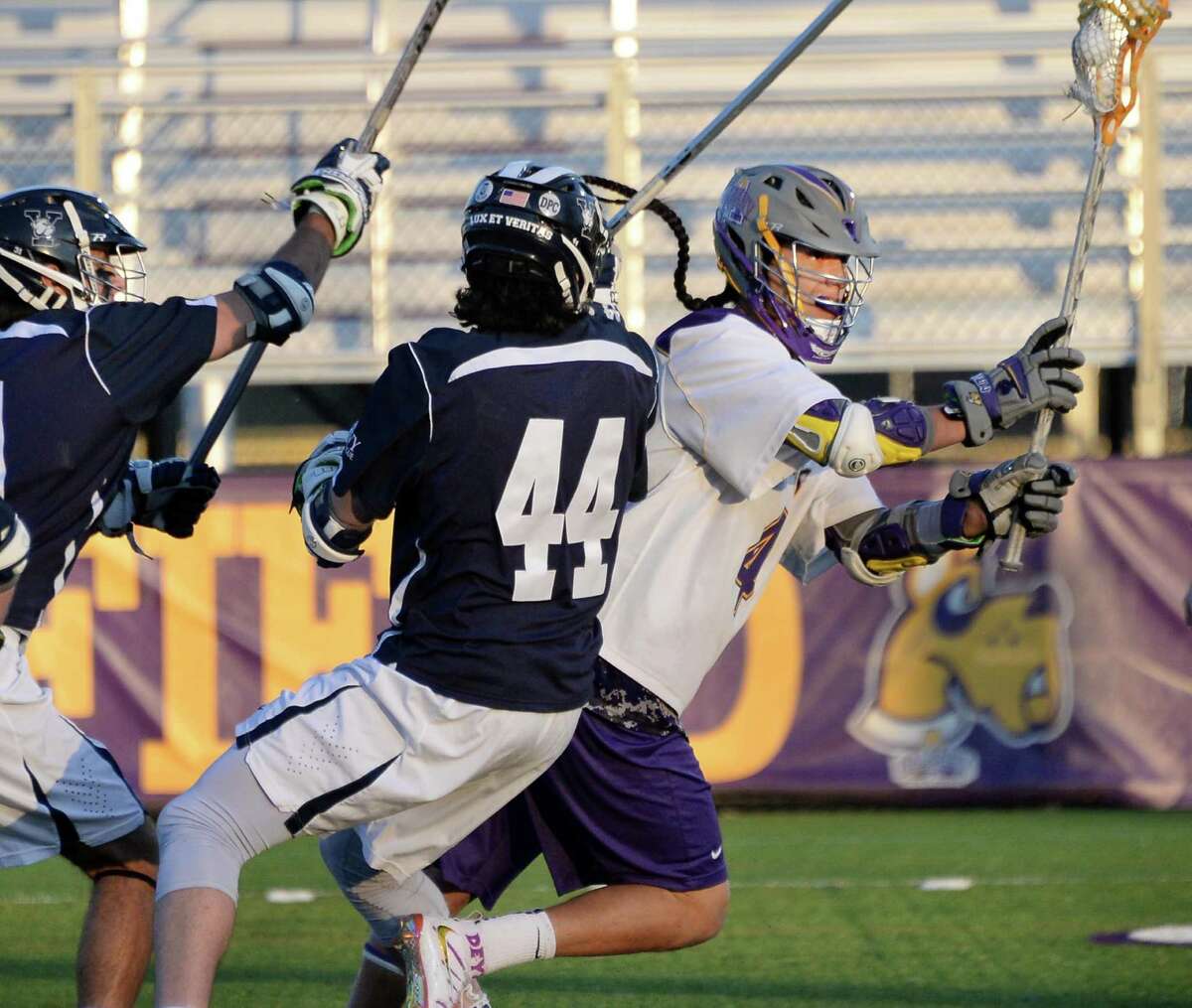 UAlbany's #4 Lyle Thompson, right, drives through Yale defenders to score during Saturday's lacrosse game April 18, 2015 in Albany, NY. (John Carl D'Annibale / Times Union)