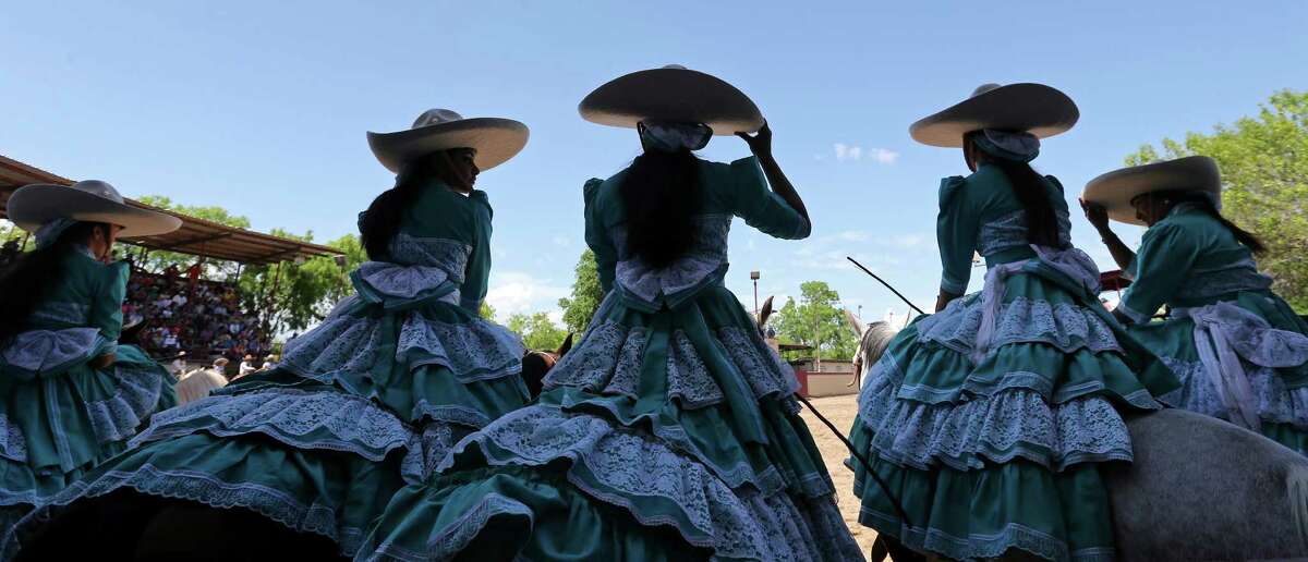 Members of the Escaramuza Las Potrancas take part in the opening ceremony of the Day in Old Mexico and Charreada event Sunday April 19, 2015 at the San Antonio Charro Ranch.