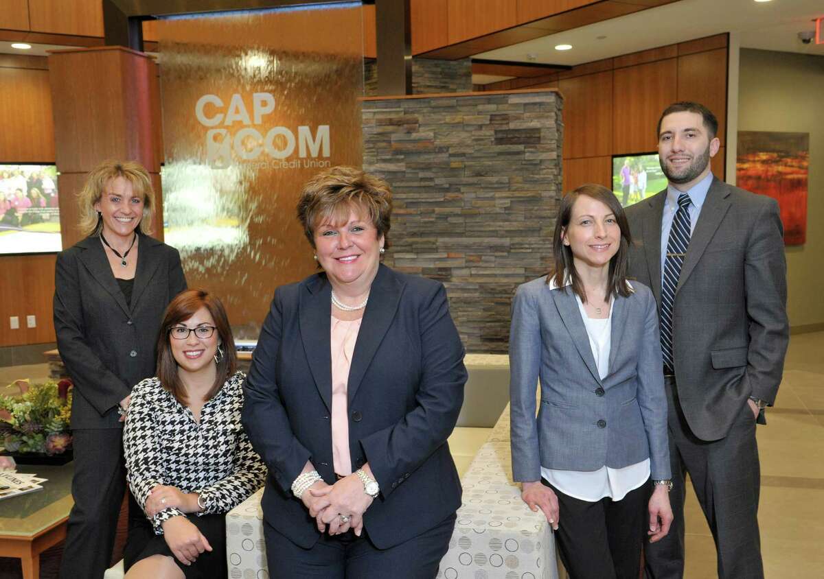 CapCom employees, from left to right, Candace Stazio, loan originator, Amanda Goyer, foundation and public relations administrator, Paula Stopera, president and CEO, Theresa Trietiak, director of H.R., and Brian Hooks, license branch representative, pose for a photograph at the CapCom Federal Credit Union on Monday, March 30, 2015, in Albany, N.Y. (Paul Buckowski / Times Union)