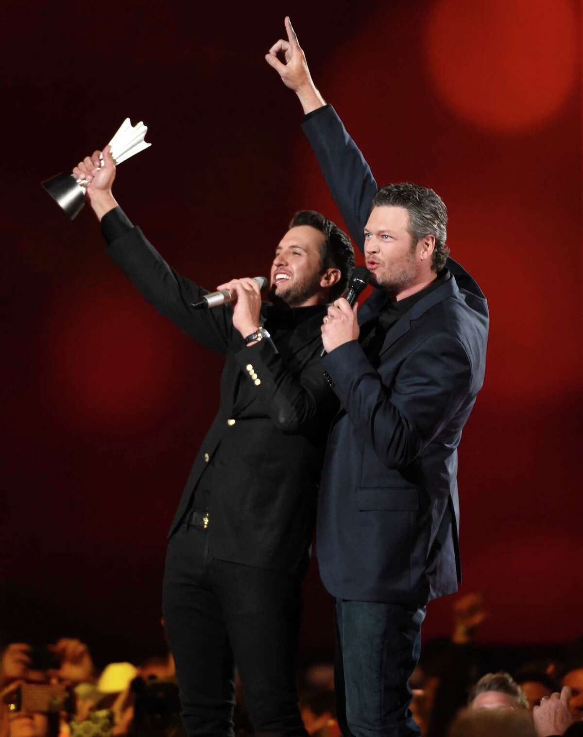Luke Bryan, left, and Blake Shelton speak on stage after Bryan accepts the award for entertainer of the year at the 50th annual Academy of Country Music Awards at AT&T Stadium on Sunday, April 19, 2015, in Arlington, Texas. (Photo by Chris Pizzello/Invision/AP) ORG XMIT: TXBR352