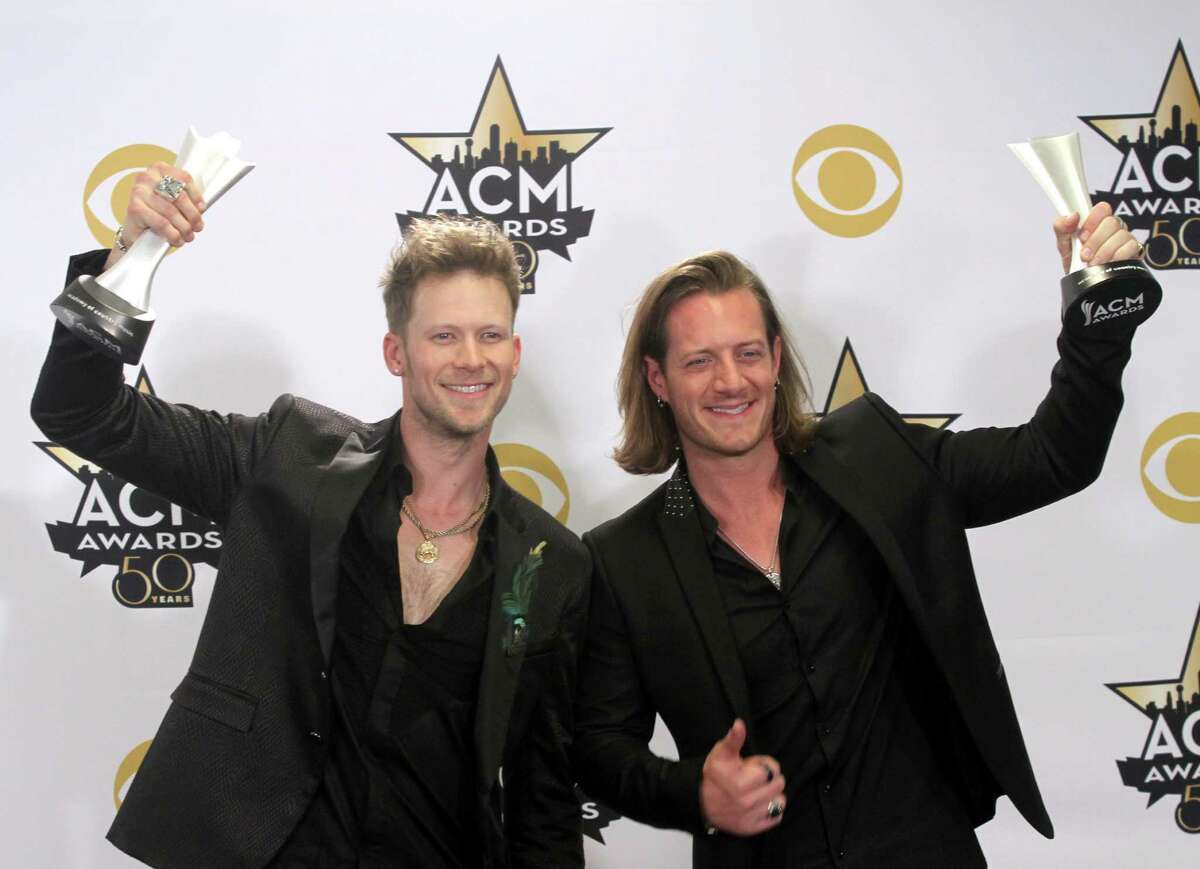 Brian Kelley, left, and Tyler Hubbard, of Florida Georgia Line, pose in the press room with the awards for vocal event of the year for "This Is How We Roll" and vocal duo of the year at the 50th annual Academy of Country Music Awards at AT&T Stadium on Sunday, April 19, 2015, in Arlington, Texas. (Photo by Jack Plunkett/Invision/AP) ORG XMIT: TXBR365