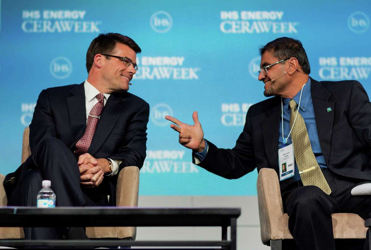 Steve Bolze, chief executive officer of GE Power & Water, left, speaks with Muhammad Al-Saggaf, acting head of shared operations and services for Saudi Aramco, at the 2015 IHS CERAWeek conference in Houston, Texas, U.S., on Monday, April 20, 2015. CERAWeek 2015, in its 34th year, will provide new insights and critically-important dialogue with decision-makers in the oil and gas, electric power, coal, renewables, and nuclear sectors from around the world. Photographer: F. Carter Smith/Bloomberg *** Local Caption *** Steve Bolze; Muhammad Al-Saggaf