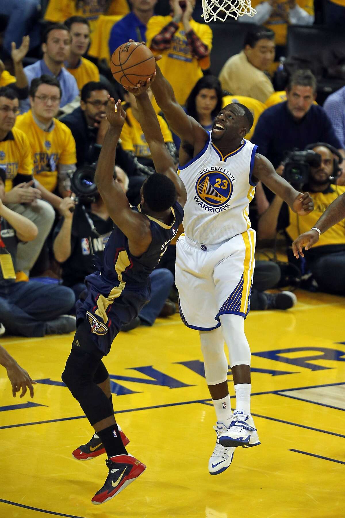 Golden State Warriors' Draymond Green blocks a shot by New Orleans Pelicans' Tyreke Evans in 2nd quarter during Game 2 of the 1st Round of NBA Western Conference Playoffs at Oracle Arena in Oakland, Calif., on Monday, April 20, 2015.