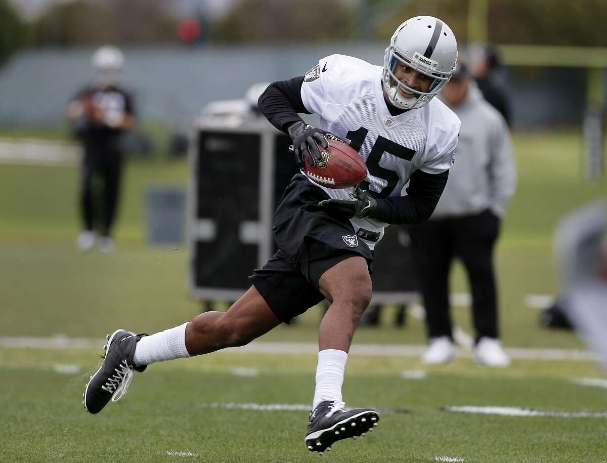 The Raiders Michael Crabtree (15) smiled as he made a catch during a drill. The Oakland Raiders held a mini-camp at their practice facility at Alameda, Calif. Tuesday April 21, 2015.