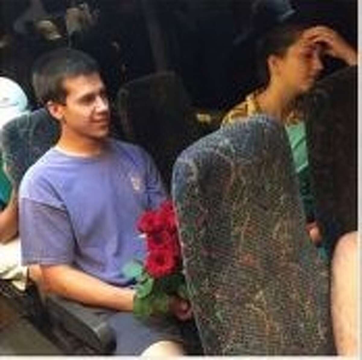 Cody Nichols holding flowers after returning to New Orleans for his date.
