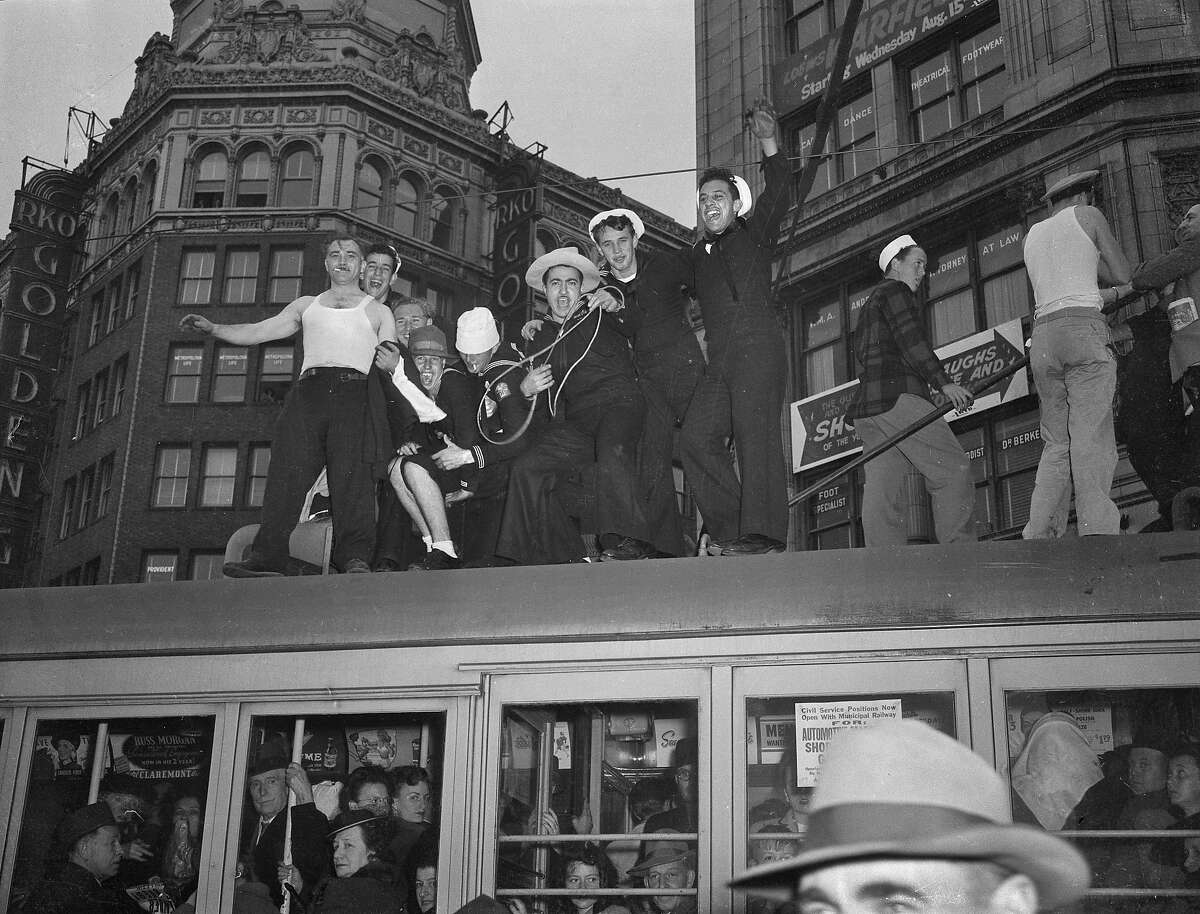 V-J Day celebration in San Francisco ..August 14-15 1945 End of World War II, Japan surrenders Men standing on top of a bus