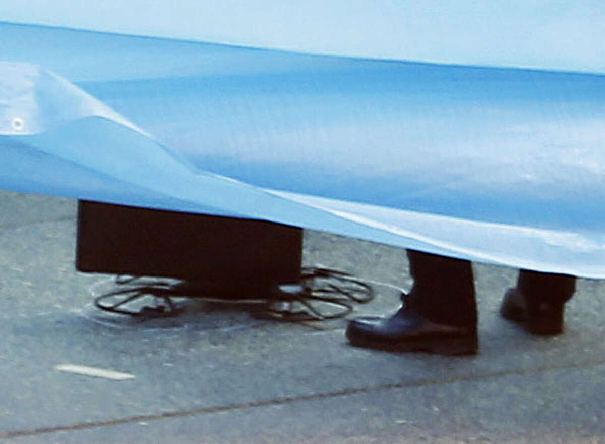 The part of a small drone covered with blue sheets, is seen on the roof of Prime Minister Shizo Abe's official residence in Tokyo Wednesday, April 22, 2015. Japanese authorities were investigating Wednesday after the small drone landed on the roof of the prime minister's office. No injuries or damage were reported from the incident, and Prime Minister Shinzo Abe was in Indonesia to attend an Asia-African conference. (Kota Endo/Kyodo News via AP) JAPAN OUT, MANDATORY CREDIT