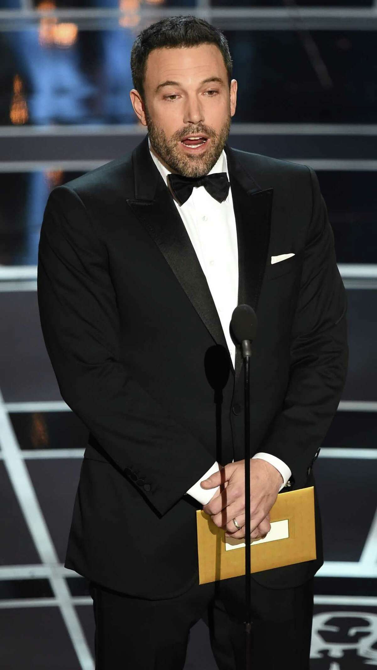 (FILES) This February 22, 2015 file photo shows Ben Affleck as he presents an award on stage at the 87th Oscars in Hollywood, California. Ben Affleck says he was "embarrassed" upon learning he had slaveholding ancestors, and regrets asking US television producers to censor that fact from a program about his family's past. Affleck was featured late last year in the television program "Finding Your Roots," a nationally broadcast program that profiles the family histories of well-known Americans.The actor -- known as an ardent supporter of liberal causes -- was dismayed to learn that in addition to a forbear who was a Revolutionary War hero, he also had a long-ago relative who was a slavemaster. AFP PHOTO / Robyn BECKROBYN BECK/AFP/Getty Images