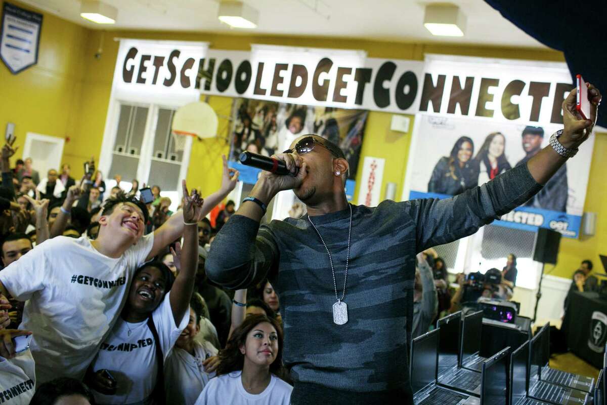 Ludacris takes a selfie with Chicago students at a Comcast Internet Essentials event. The program offers broadband service to families with low incomes.﻿﻿