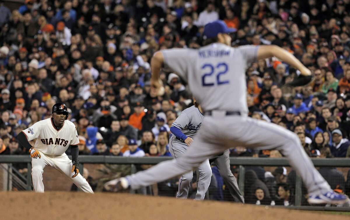 Joaquin Arias (13) leans off first as Clayton Kershaw (22) pitches in the third inning as the San Francisco Giants played the Los Angeles Dodgers at AT&T Park in San Francisco, Calif., on Wednesday, April 22, 2015.