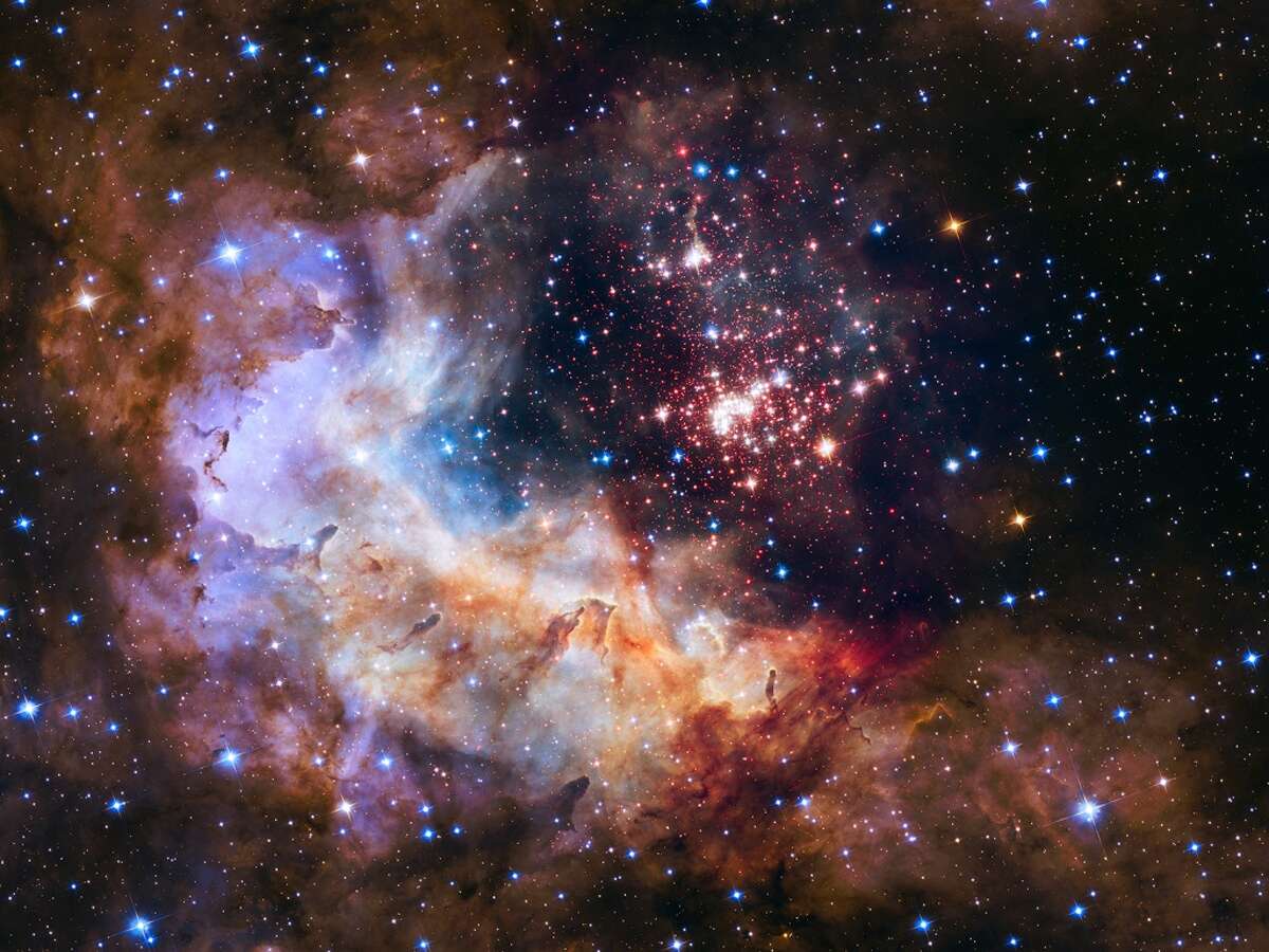 The official photo of Hubble's 25th year anniversary. NASA caption: The sparkling centerpiece of Hubble’s anniversary fireworks is a giant cluster of about 3,000 stars called Westerlund 2, named for Swedish astronomer Bengt Westerlund who discovered the grouping in the 1960s. The cluster resides in a raucous stellar breeding ground known as Gum 29, located 20,000 light-years away from Earth in the constellation Carina.