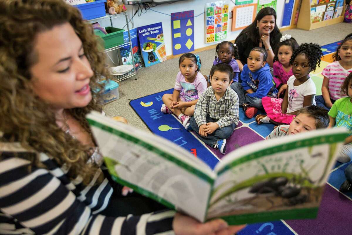Pre-K teacher Vanessa de Simone Canseco reads to her class at Marshall Elementary School on Friday, April 17, 2015, in Spring.
