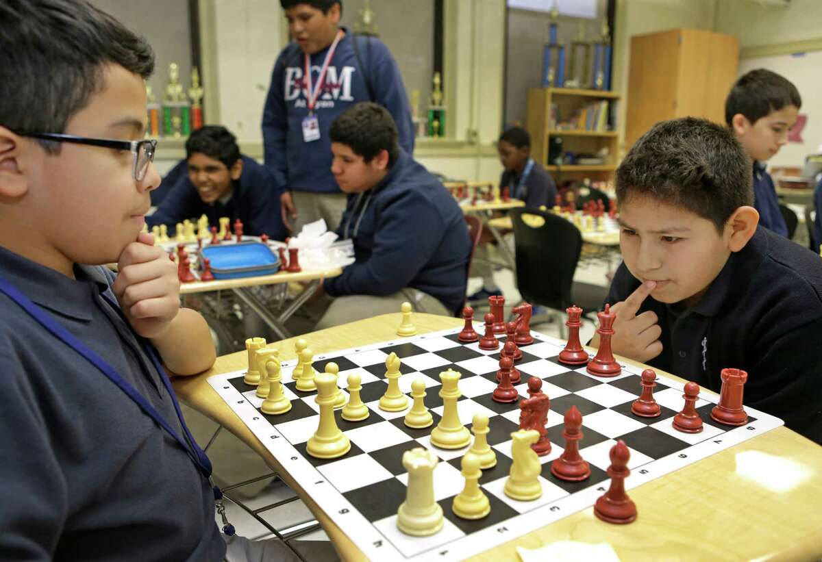 Sixth graders Joseph Mazariego, 12, left, and Roland Reyes, 12, right, play chess during their lunchtime at Baylor College of Medicine Academy at Ryan, 2610 Elgin, Thursday, April 16, 2015, in Houston.