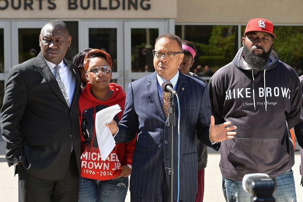 CLAYTON, MO - APRIL 23: Brown family attorney, Benjamin L. Crump speaks to the media along with Lesley McSpadden (L) and Michael Brown Sr. (R) during a press conference outside the St. Louis County Court Building on April 23, 2015 in Clayton, Missouri. Family members have announced a civil lawsuit over the death of Michael Brown Jr. this past August in Ferguson, Missouri.