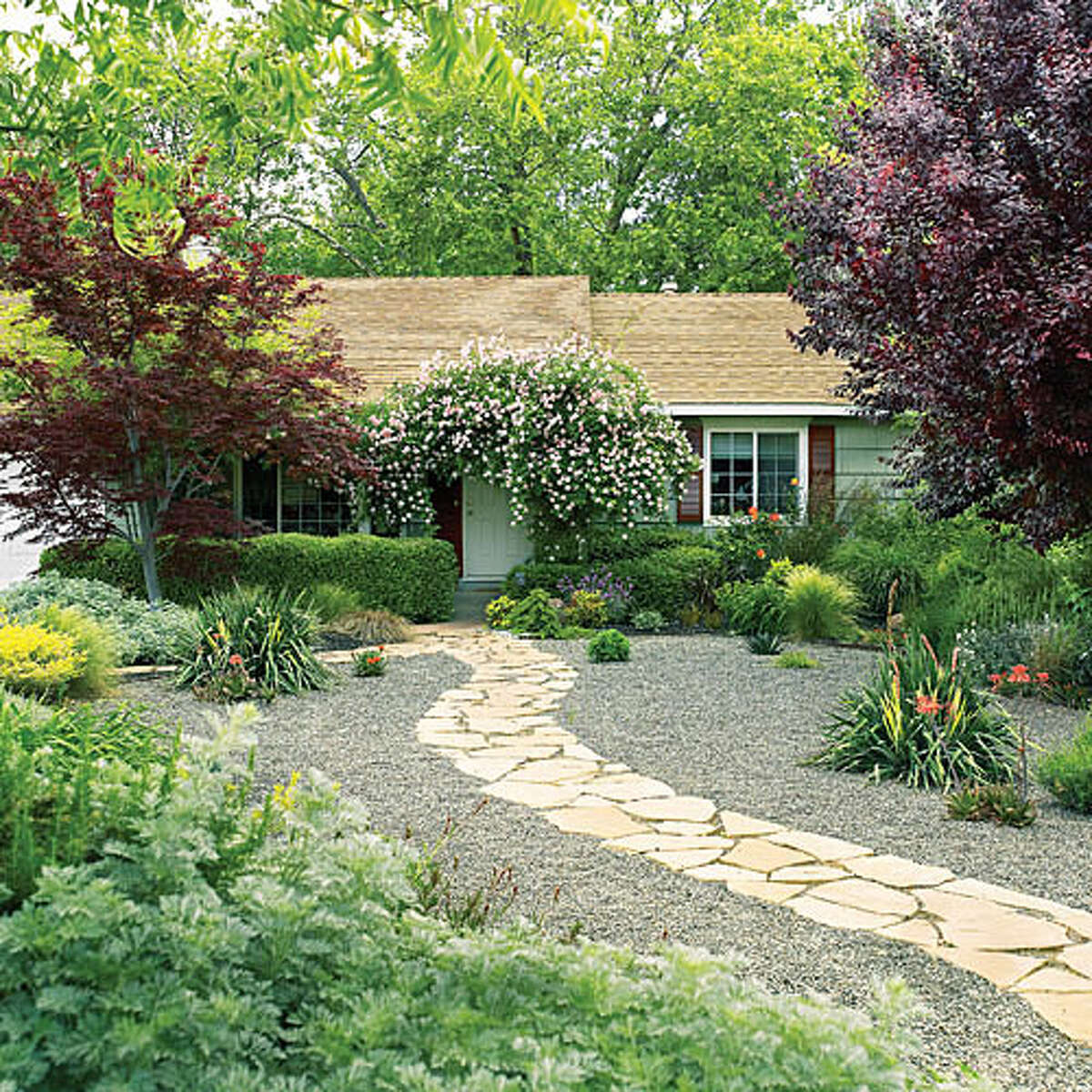 Easy-care front yard Flagstone paths curve through a low-water front yard. 