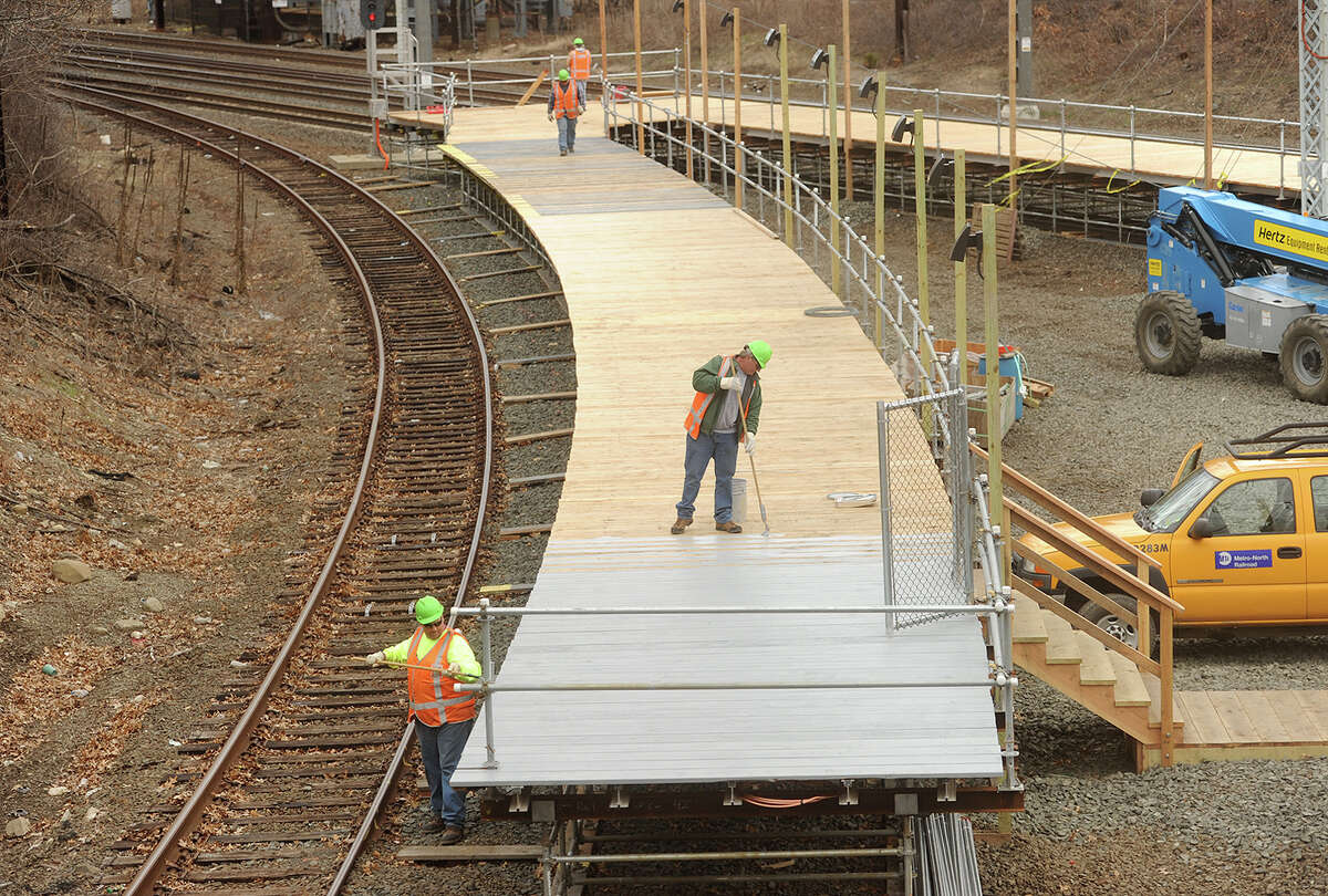 In preparation for work to begin on the Devon Bridge, Metro North workers construct a temporary train platform for passenger transfers between the Waterbury and New Haven lines in the Devon section of Milford, Conn. on Thursday, April 23, 2015.