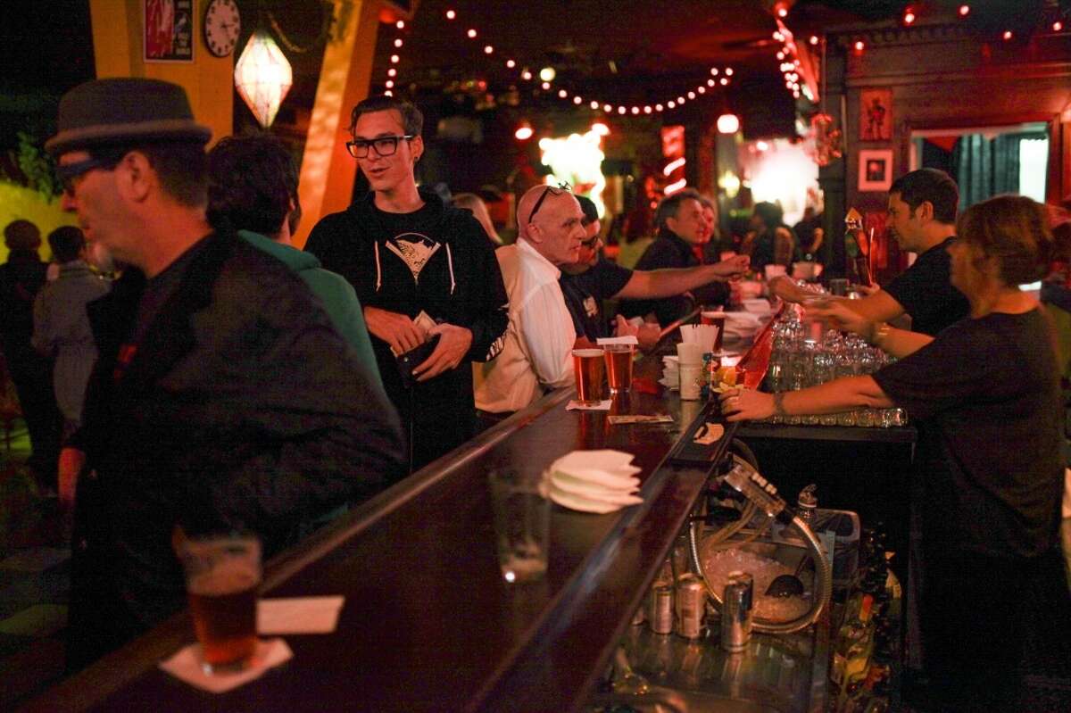 People mingle at the bar at Bottom of the Hill in San Francisco on August 8th 2014.