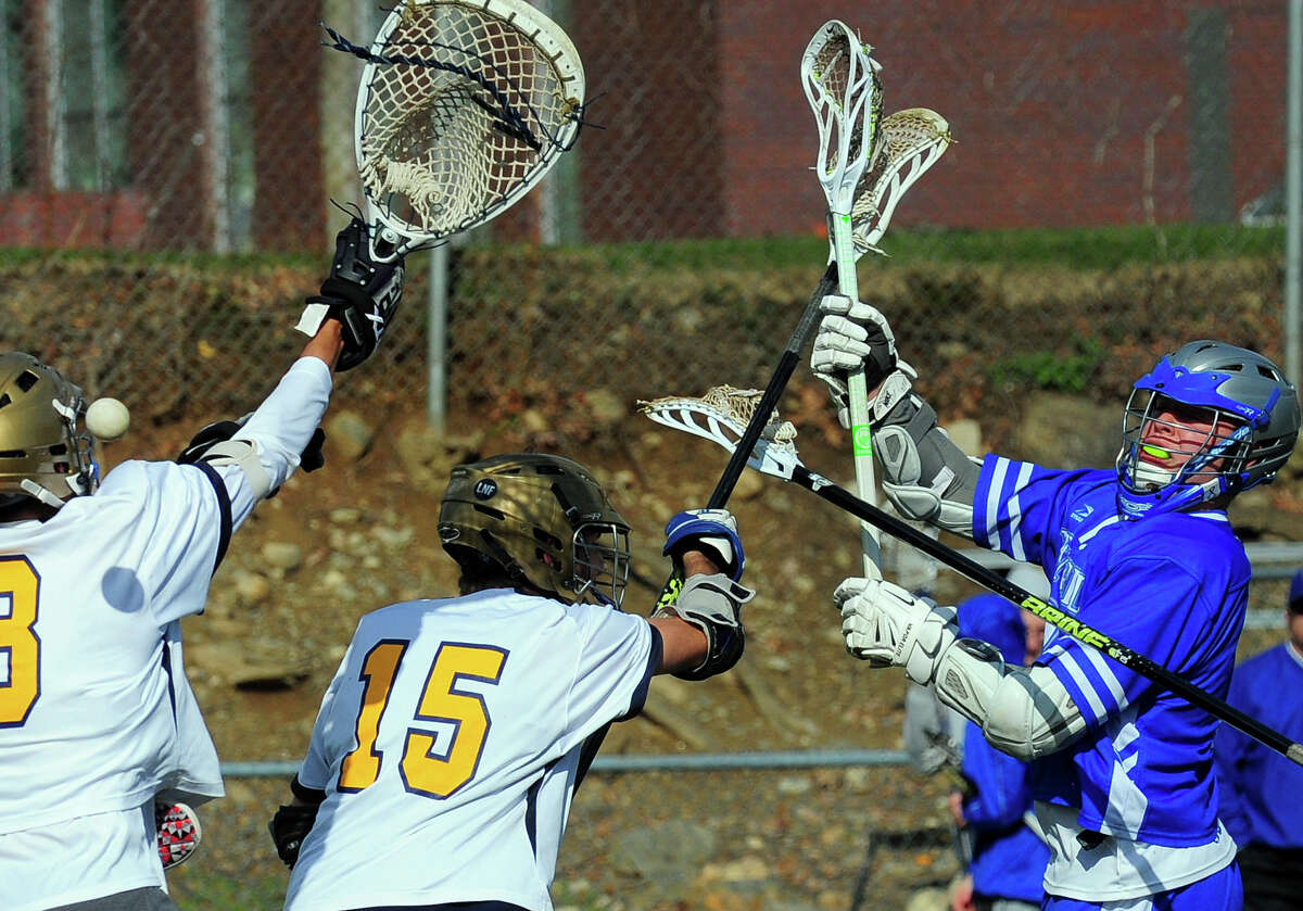 Bunnell's Michael Celentano, right, sends the ball past Notre Dame of Fairfield goailie Andres Rosales to score, during boys lacrosse action in Fairfield, Conn., on Thursday Apr. 23, 2015.
