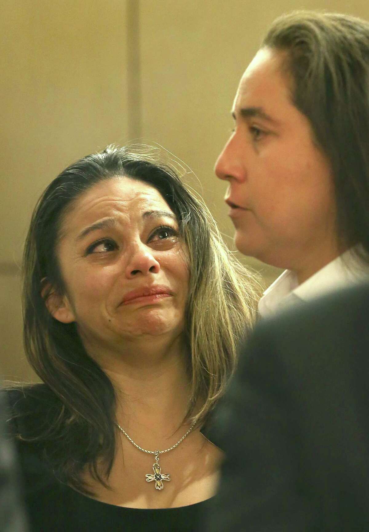 Elizabeth Ramirez, left, looks up to Anna Vasquez for reasuring words at the end of the second day of hearings for the SA Four, Anna Vasquez, Elizabeth Ramirez, Kristie Mayhugh and Cassandra Rivera. They were back in Bexar County Court to determine if they should be declared actually innocent of a sexual crime that they were found guilty of, or possibly sent back to prison. Ramirez could face having to finish out her sentence of 20 more years. Thursday, April 23, 2015.