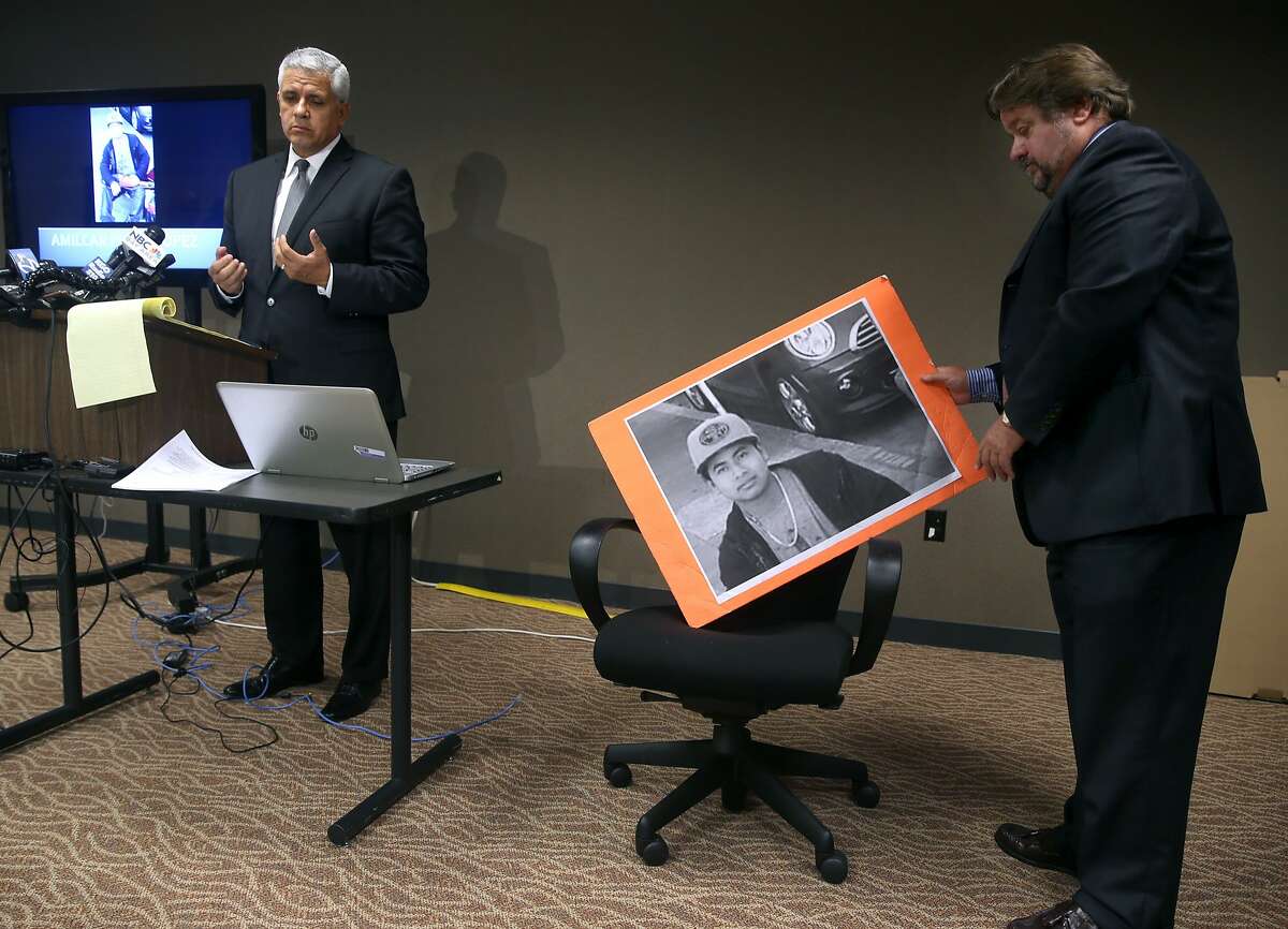 Agustin Pradillo adjusts a large photograph of Amilcar Perez Lopez as attorney Arnoldo Casillas (left) announces a federal lawsuit has been filed against the police department and Chief Greg Suhr, at a new conference in San Francisco, Calif. on Friday, April 24, 2015. Attorneys allege that police officers killed Lopez on Feb. 26 while he was running from police, disputing the department's version that Lopez had lunged at officers with a knife.