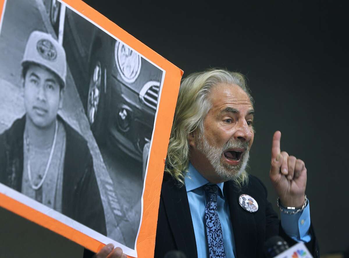 Attorney Jonathan Melrod holds up a photo of Amilcar Perez Lopez at a new conference in San Francisco, Calif. on Friday, April 24, 2015 to announce a federal lawsuit filed against the police department and Chief Greg Suhr. Attorneys allege that police officers killed Lopez on Feb. 26 while he was running from police, disputing the department's version that Lopez had lunged at officers with a knife.
