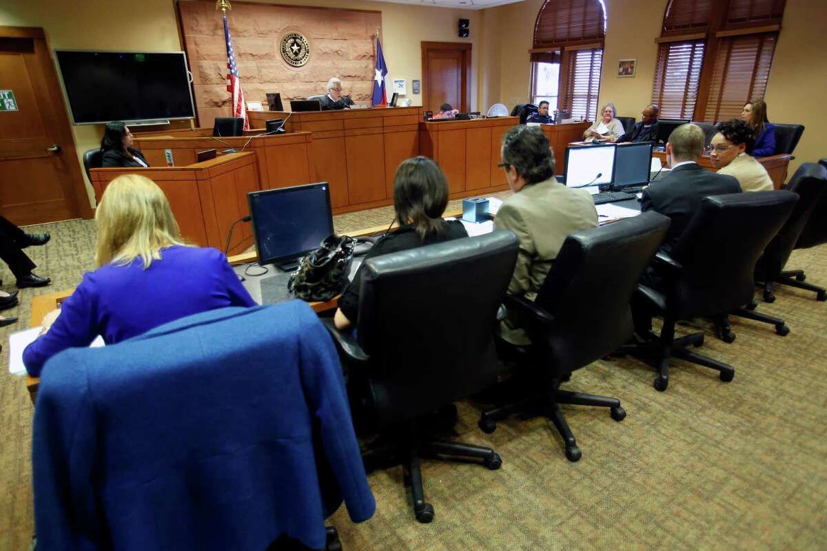 The mother of two children, second from left, sits in court Wednesday March 11, 2015 during a hearing in Judge Richard Garcia's courtroom. Judge Peter Sakai is overseeing a "redesign" of Children's Court, which deals with families that have entered CPS system. Begun two months ago, the redesign models off of Family Drug Court, where parents are innundated with services to overcome addiction and to keep or get their kids back, and the approach is far less adversarial than traditional CC. The goal is to safely reunify more kids with familes that have gone through CPS, to empower families instead of punish them and keep more families intact