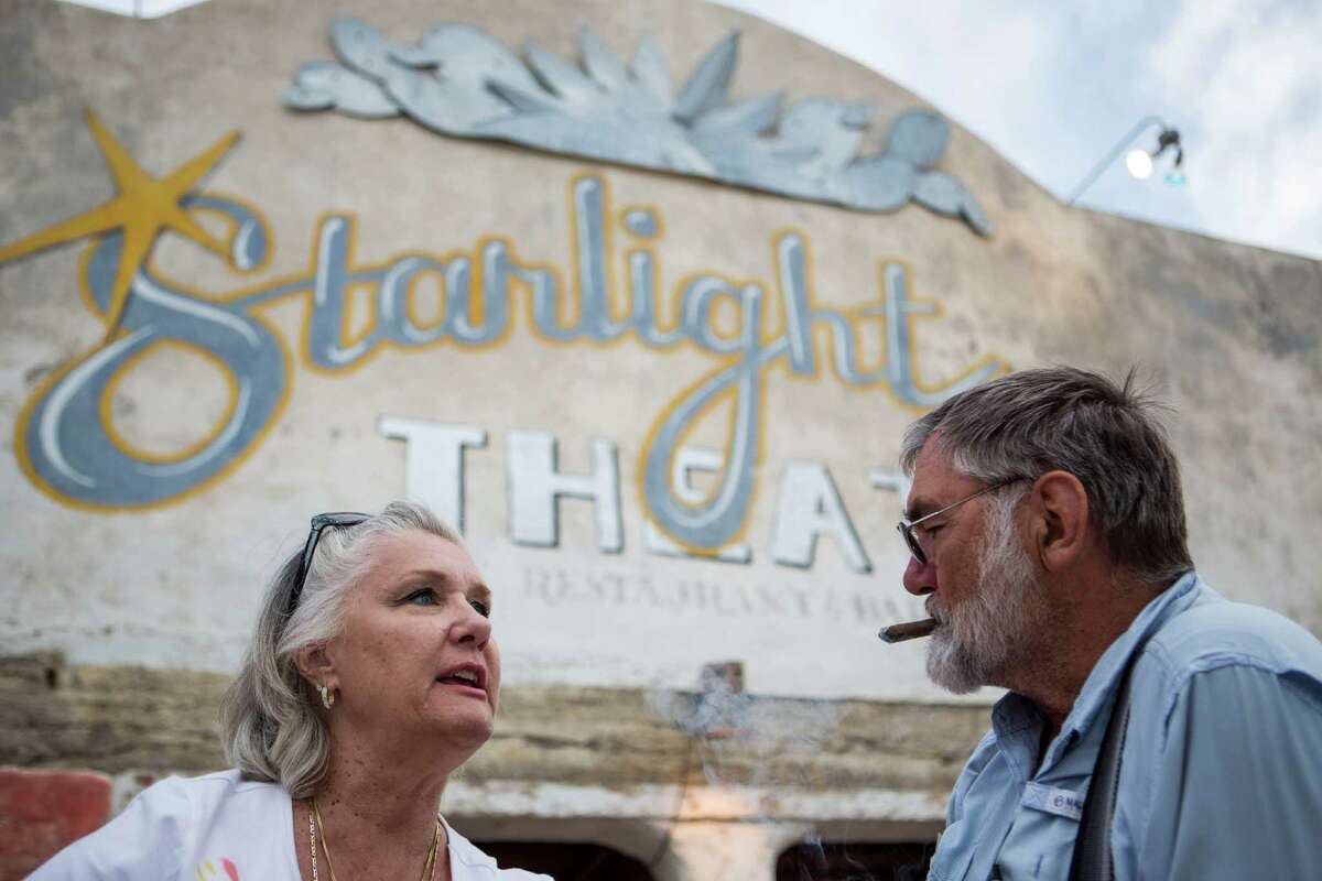 C.C. Krull talks to her husband Robert Krull as he smokes a cigar on the porch of the Starlight Theatre in Terlingua, TX on April 20, 2015. Although they have been staying at the Study Butte RV Park, they are building a home in Terlingua because they fell in love with the place, C.C. Krull said.