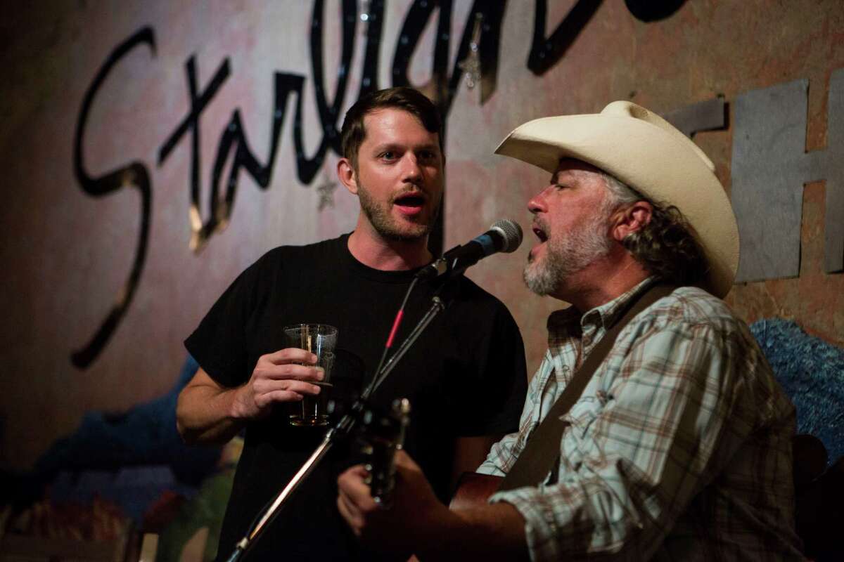 Kyle Garmany, left, sings with Jeff Haislip at the Starlight Theatre in Terlingua, TX on April 20, 2015. Garmany was traveling through from Austin and joined in Haislip's performance for a song even though they had not previously met. Artists perform regularly at the Starlight Theatre and on the porch attached to it.