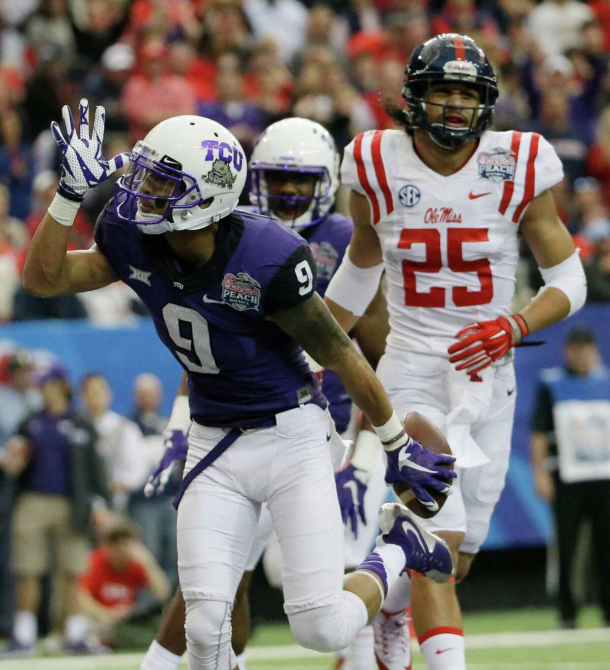 TCU wide receiver Josh Doctson (9) makes the “land shark” sign after his touchdown against Mississippi during the first half of the Peach Bowl NCAA on Dec. 31, 2014, in Atlanta.
