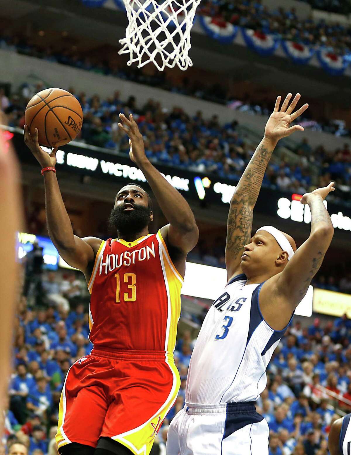 Houston Rockets guard James Harden goes for a lay-up while Dallas Mavericks forward Charlie Villanueva defends during the first half of Game 4 in the first round of NBA basketball playoffs at the American Airlines Center Sunday, April 26, 2015, in Dallas. ( James Nielsen / Houston Chronicle )
