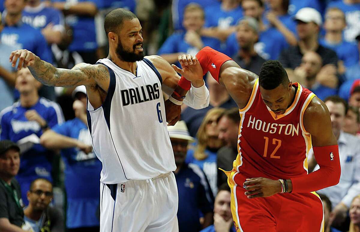The Mavs' Tyson Chandler, left, and the Rockets' Dwight Howard tangle as more than 500 pounds of NBA centers mix it up for a double technical in the second half.