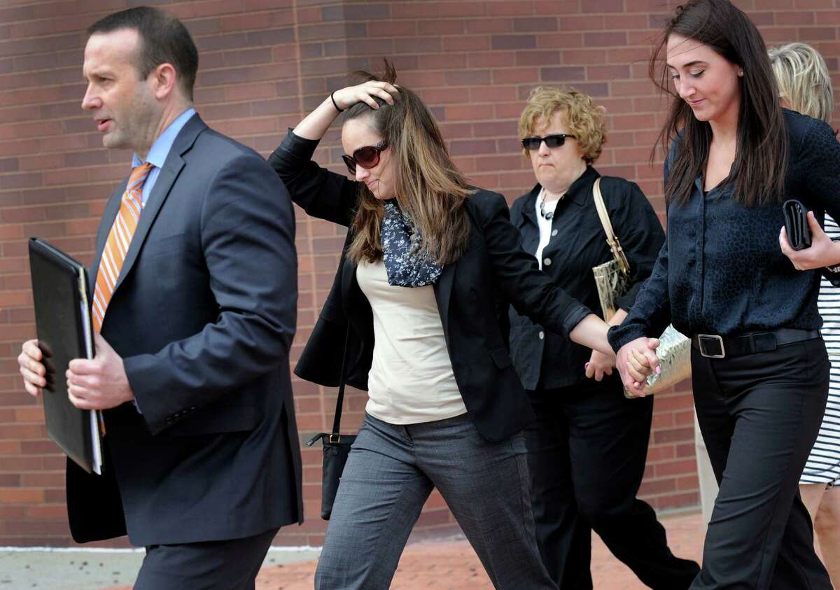 Kayla Mooney, second from left, leaves Danbury Superior Court with her attorney and supporters Monday morning, April 27, 2015. Mooney, a Danbury High School teacher, is charged with the sexual assault of a 17-year-old student.