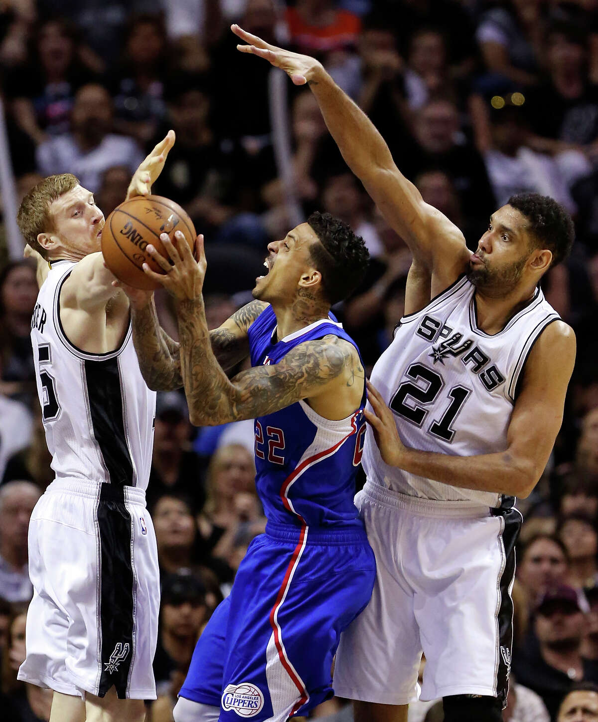 San Antonio Spurs' Matt Bonner and Tim Duncan defend Los Angeles Clippers' Matt Barnes during second half action of Game 4 in the Western Conference playoffs Sunday April 26, 2015 at the AT&T Center. The Clippers won 114-105.