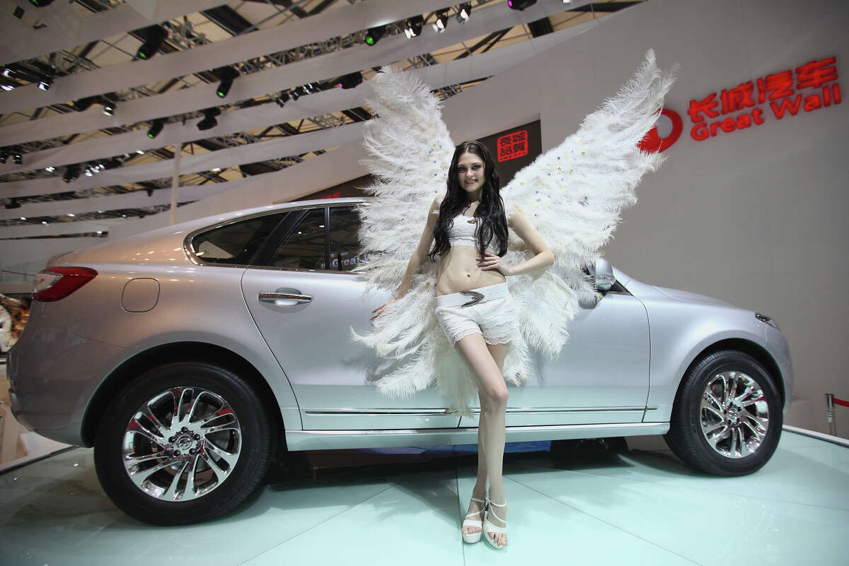 FILE--A model poses with a car on display during the 12th China (Guangzhou)  International Automobile Exhibition, also known as Auto Guangzhou 2014  Stock Photo - Alamy