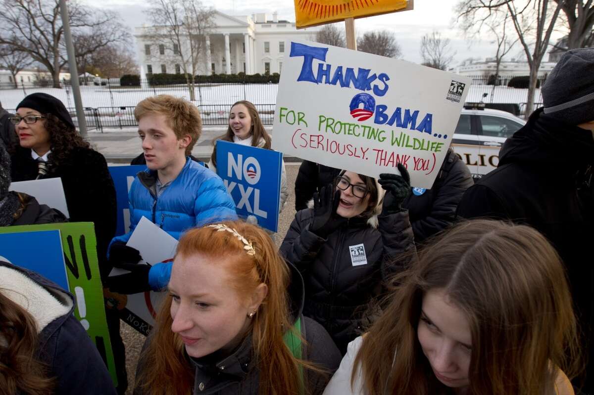 Samantha Lockhart, 26, center, with the National Wildlife Federation, holds a sign thanking President Obama for protecting wildlife, as she gathers with other opponents of Keystone XL to celebrate President Barack Obama's veto of the legislation outside the White House in Washington, Tuesday, Feb. 24, 2015, (AP Photo/Jacquelyn Martin)