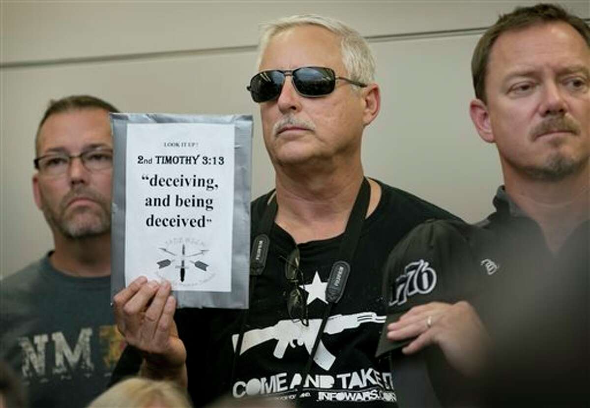 Bob Welch holds a sign at a public hearing about the Jade Helm 15 military training exercise in Bastrop, Texas, Monday April 27, 2015. (Jay Janner/Austin American-Statesman via AP) AUSTIN CHRONICLE OUT, COMMUNITY IMPACT OUT, INTERNET AND TV MUST CREDIT PHOTOGRAPHER AND STATESMAN.COM, MAGS OUT