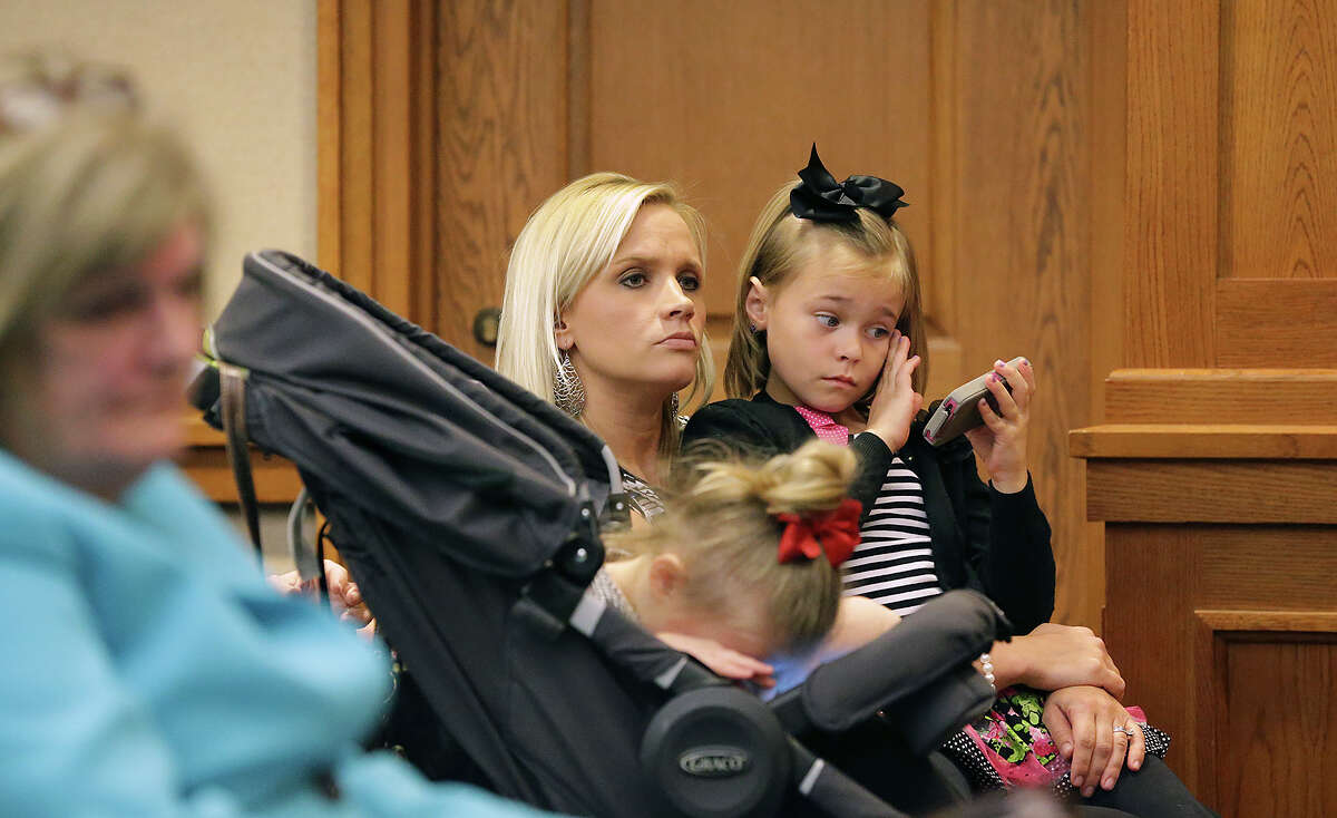 Shawna Davis waited with her two daughters, Karly, left, and Kendall as families listen to testimony Tuesday before the House of Representatives Committee on Public Health in Austin concerning legalization of CBD oil as a medicine for people with uncontrollable seizures.