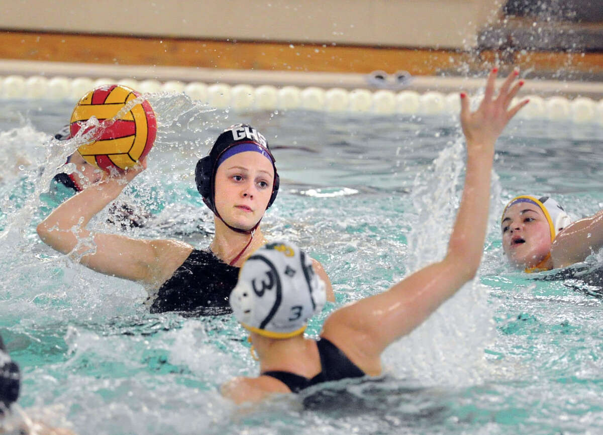 At left, Porter Carlson of Greenwich High School prepares to shoot as Borden Wahl (#3) of Greenwich Academy defends during the girls high school water polo match between Greenwich High School and Greenwich Academy at the Greenwich High School pool, Tuesday afternoon, April 28, 2015.