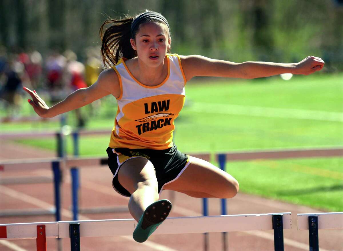 Jonathan Law's Molly Mercaldo clears the last hurdles as she competes, during boys and girls track action at Foran High School in Milford, Conn., on Tuesday Apr. 28, 2015.