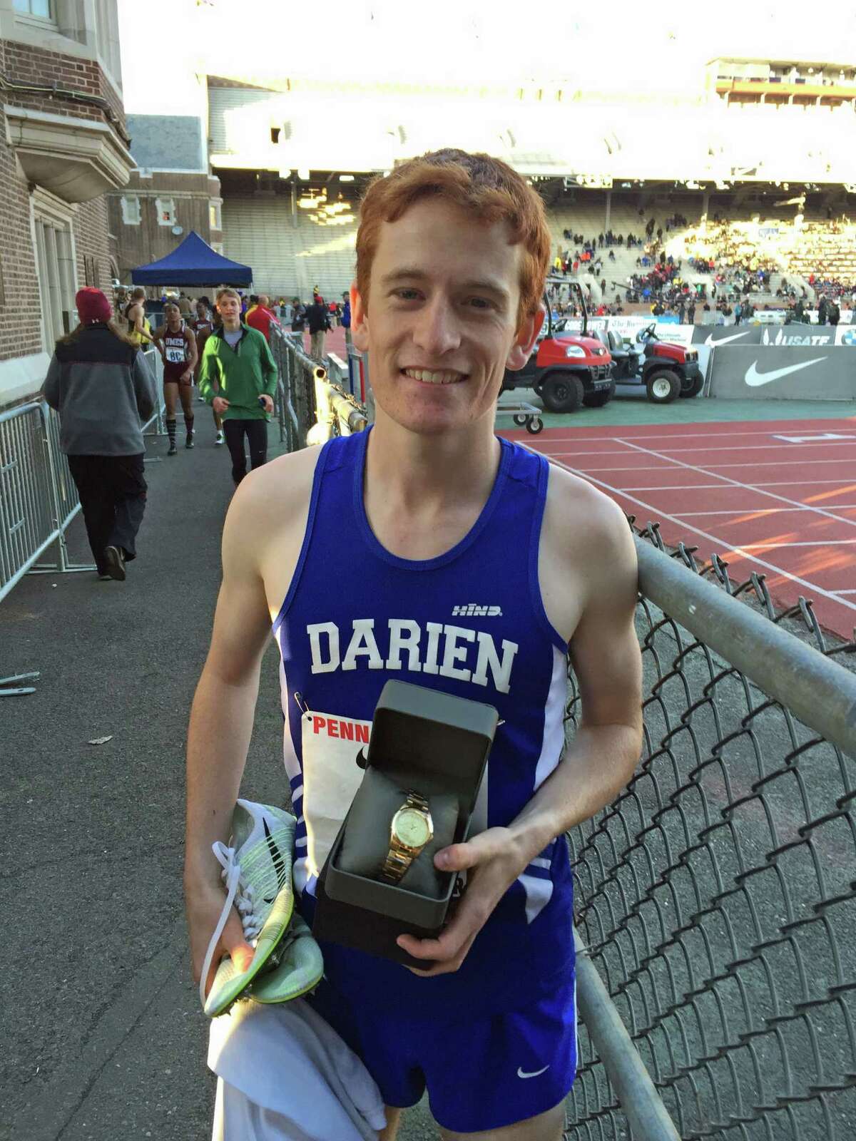 Alex Ostberg poses with a watch, his prize for a victory at the Penn Relays.