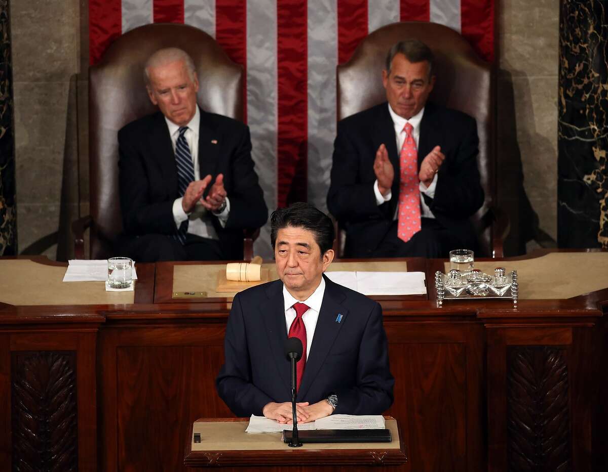 WASHINGTON, DC - APRIL 29: Japanese Prime Minister Shinzo Abe (C) speaks to a joint meeting of the US Congress while flanked by Vice President Joseph Biden (L) and House Speaker John Boehner (R-OH) (R) in the House chamber of the US Capitol April 29, 2015 in Washington, DC. The Prime Minister and his wife are on an official visit to Washington. (Photo by Mark Wilson/Getty Images) *** BESTPIX ***