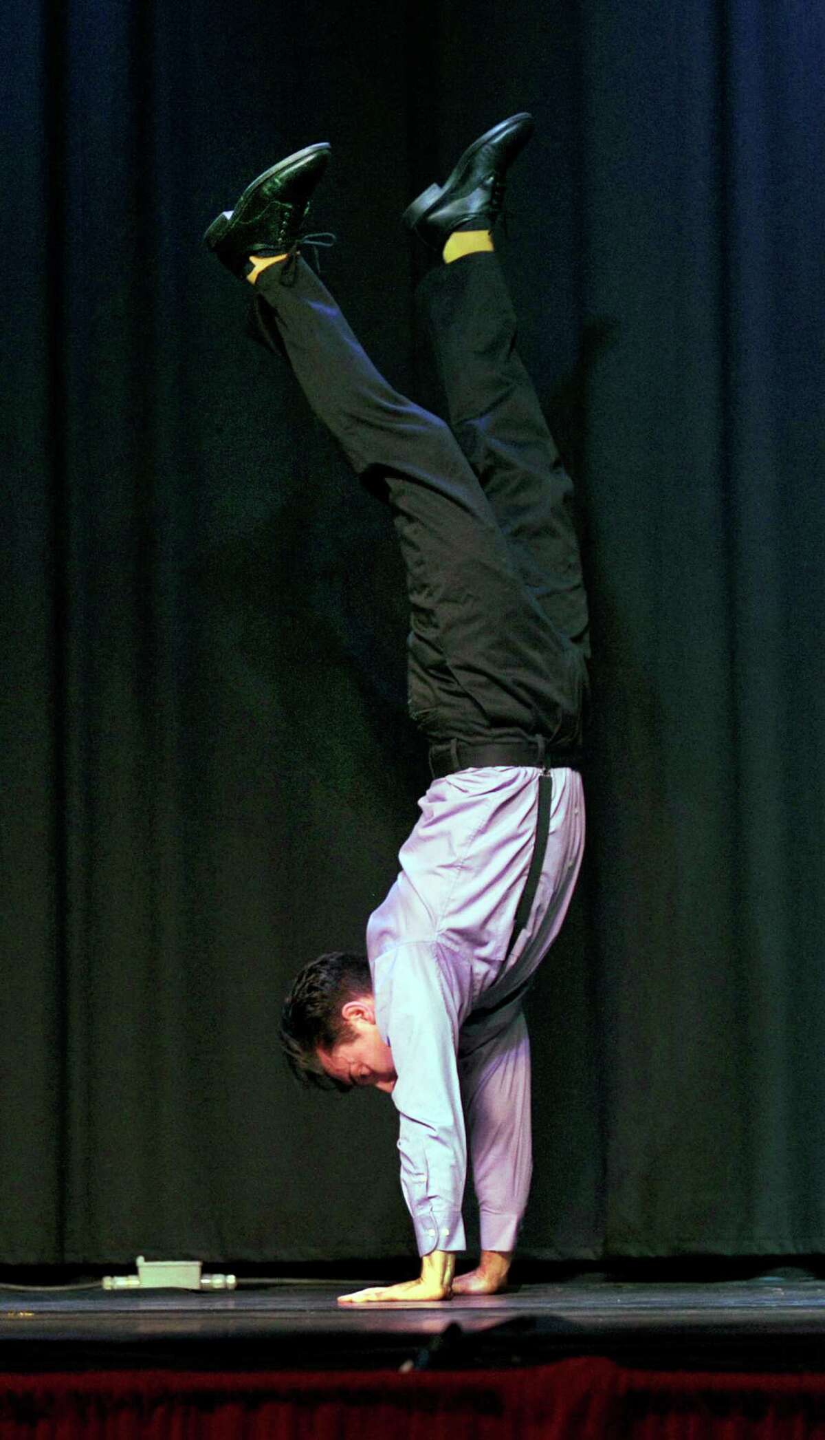 State Representative David Arconti starts his dance number walking on his hands. A local version of "Dancing With the Stars" was held at The Palace Theater on Main Street in Danbury, Conn., Saturday, April 25, 2015 as a fundraiser to benefit Danbury Youth Services.